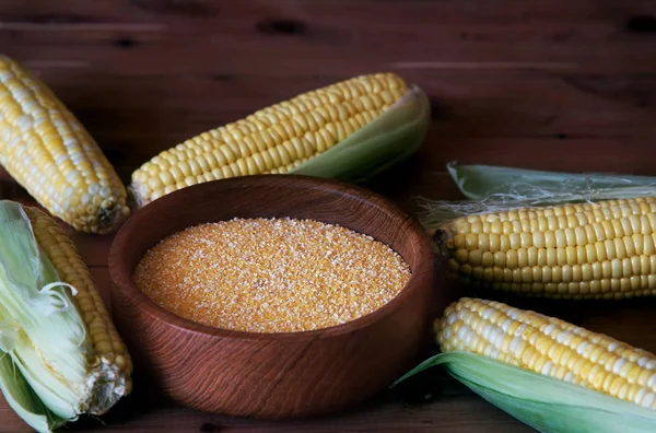 Corn grits on a wooden background