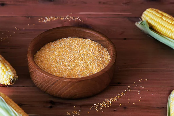 Corn grits on a wooden background