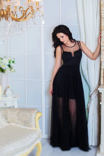 Young successful woman or teenager in evening black dress. Prom Dress.Long black small transparent dress. — Stock Photo, Image