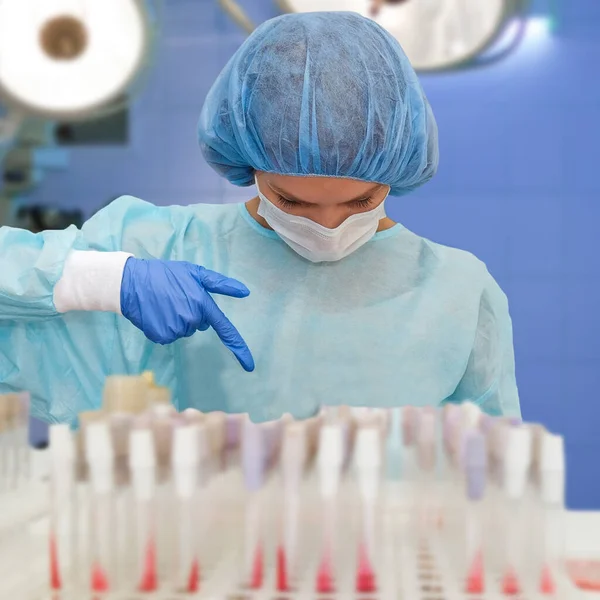 Portrait of doctor in scrubs. A female doctor in a protective cap and face mask in safety measures against the coronavirus.