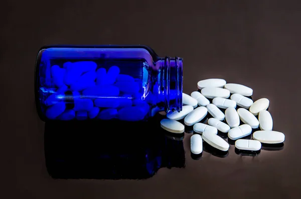 Таблетки лекарства на черном фоне — стоковое фото