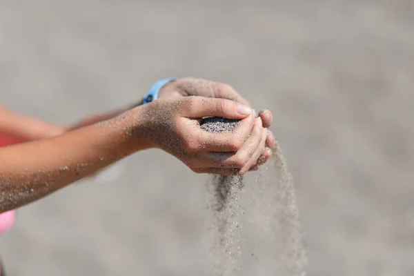 Junge Frau mit Sand in den Händen — Stockfoto