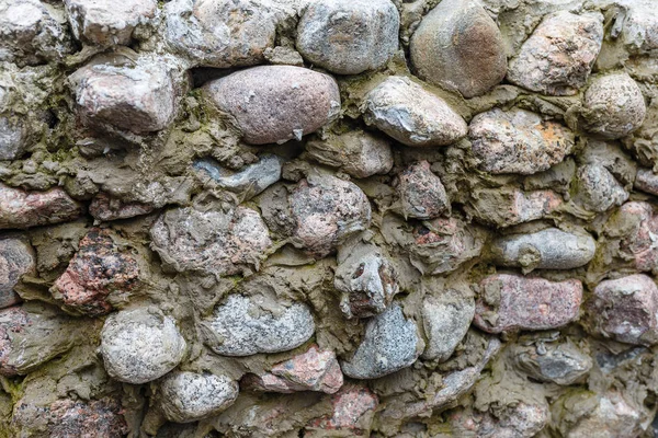 水泥墙中的石材质感.石材背景设计与文本或图像的复制空间.自然发生的石头的动机. — 图库照片