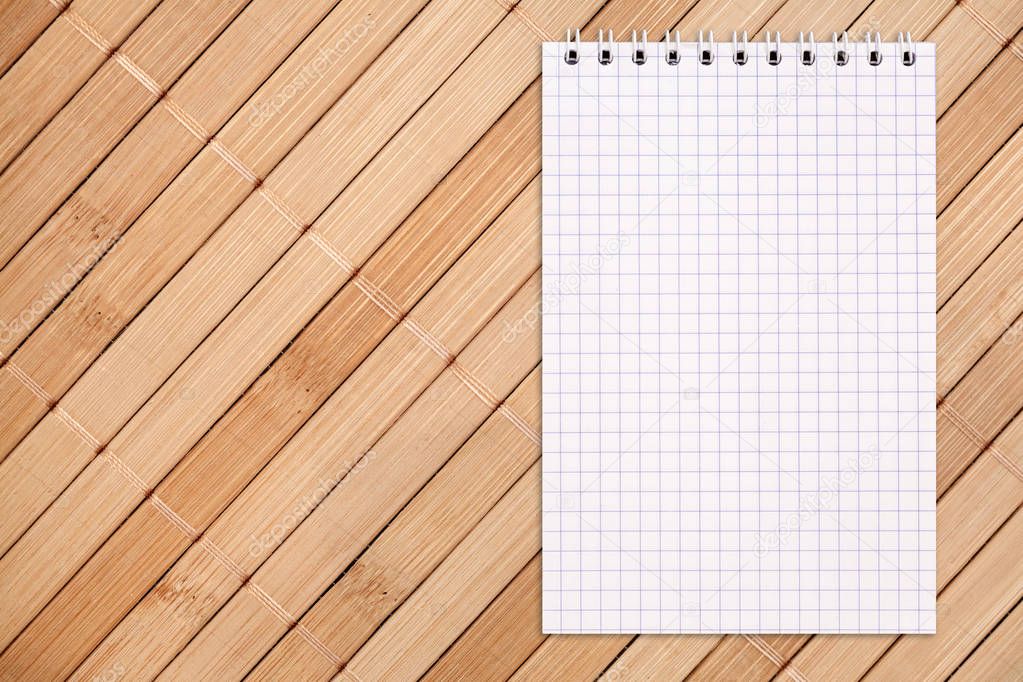 Blank notebook on a wooden background, copy space, top view