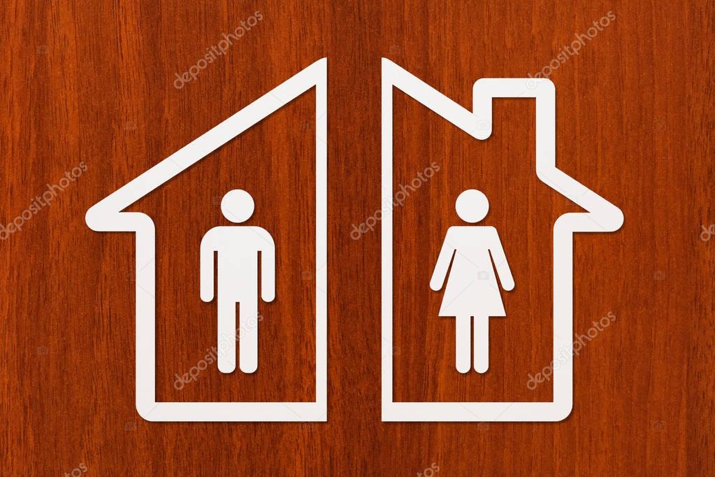 Paper house with man and woman inside. Divorce concept