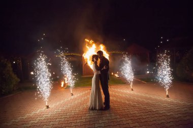 Young groom and bride with two burning hearts fireshow clipart