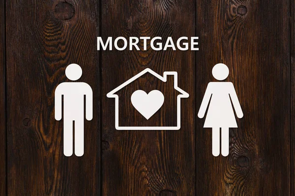 Paper house and family with mortgage text. Conceptual image — Stock Photo, Image