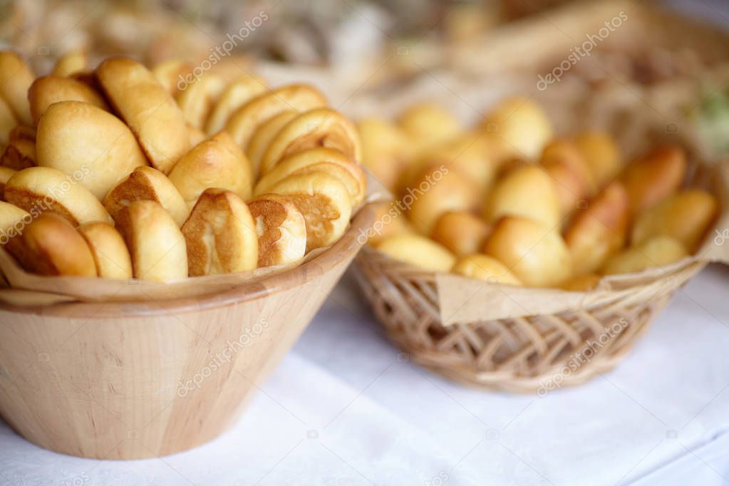 Bowl of oven fresh baked patties, russian pirozhki