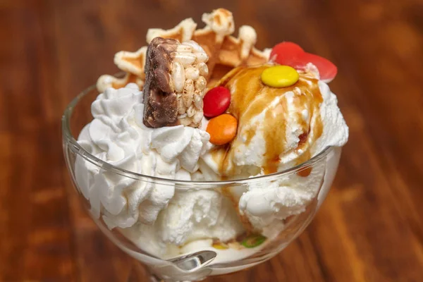 Ice cream cocktail in bowl with syrup and other treats — Stock Photo, Image