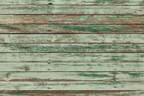 Vieilles planches de bois vert minable avec de la peinture de couleur fissurée — Photo