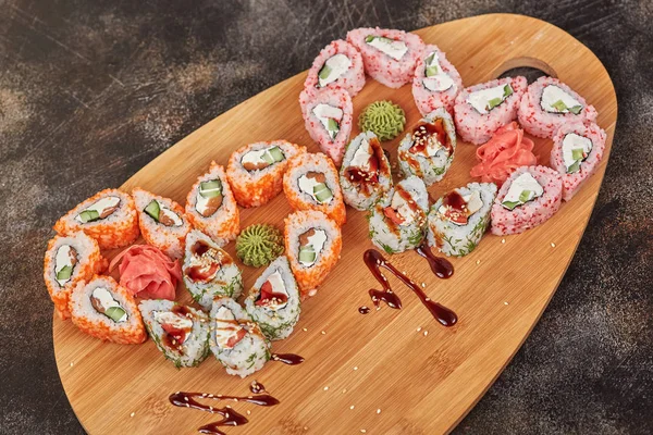 Japanese food sushi maki rolls on wooden board, heart shape
