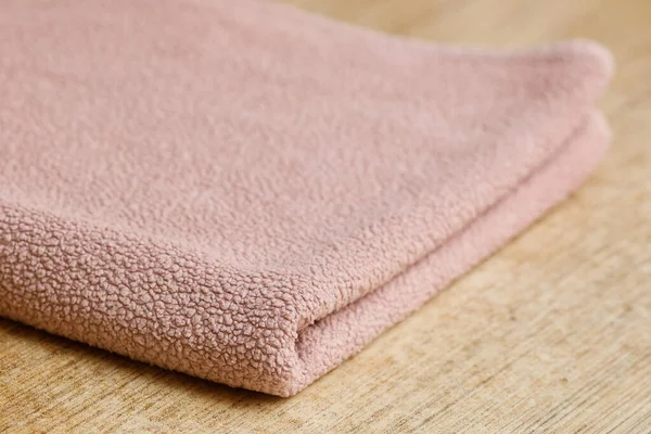 Big soft pink folded towel on table — Stockfoto