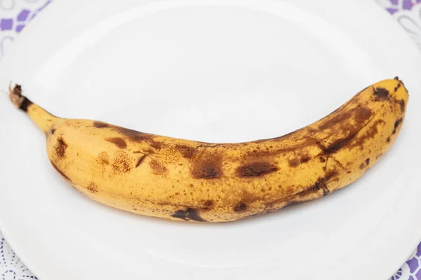 Overripe Spotted Rotten Banana White Plate Closeup — Stock Photo, Image