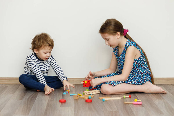 Boy and girl sitting and playing. Stay home concept, quarantine from Coronavirus Covid-19