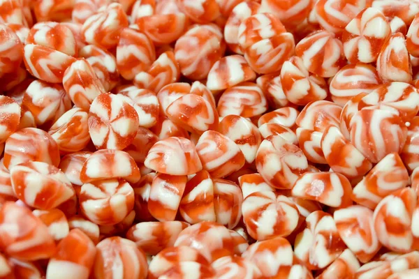 La crema blanca roja remolinó al grupo de bocadillos de caramelo duro. fresa y vainilla dulces fondo . — Foto de Stock