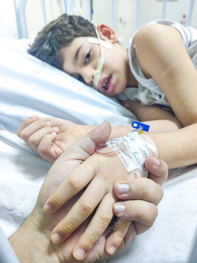 hospitalized and sad sick child taking serum