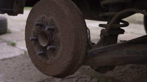 Enfoque cercano en sucias manos mecánicas atornillando grandes pernos de rueda mientras cambia el neumático pinchado en la furgoneta — Vídeos de Stock