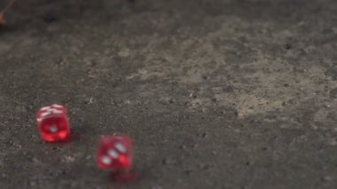 Kırmızı zar yavaş çekimde bir betonarme döşeme üzerinde haddeleme