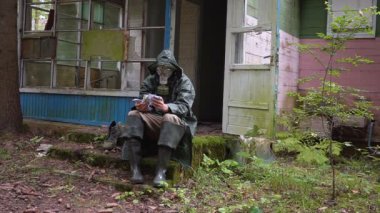 bir gaz maskesi kıyamet manzara adamla para sayar ve sokağa atıyor.