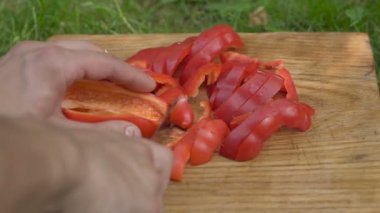 bir kesme tahtası üzerinde kırmızı biber dilimleri