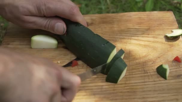 Hombre preparando calabacín al aire libre — Vídeos de Stock