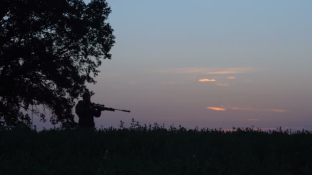 Man goes hunting with a gun at sunrise 4k — Stock Video