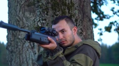 Ava bir ağacın arkasında silahlı adam