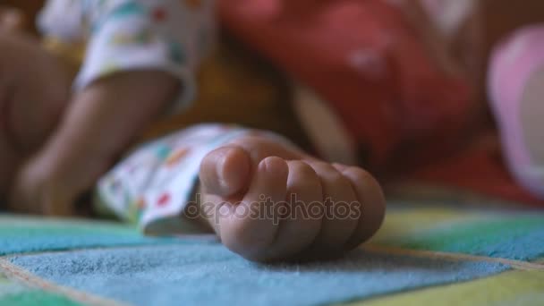 Portrait of a sleeping and waking up baby in bed — Stock Video