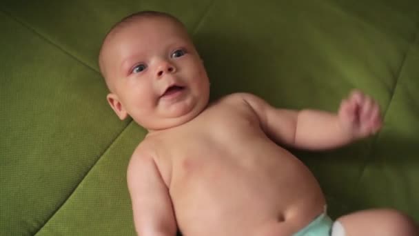 Happy newborn baby yawns closeup in white bed — Stock Video