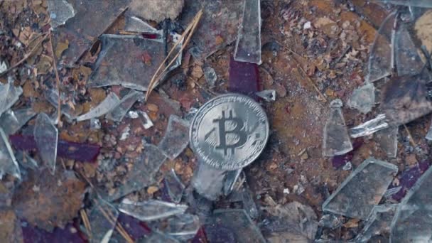 Silver bitcoin falls on broken glass — Stock Video