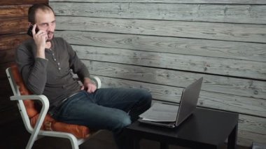 Beyaz genç freelancer görüşmeler telefon ve başarı hakkında görüşmeler