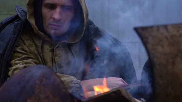 Porträt eines Obdachlosen vor einem Feuer, Nahaufnahme — Stockvideo