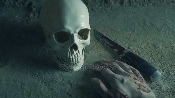 Killer maniac with a knife on the background of the skull. Bloody Hand. killing concept — Stock Video