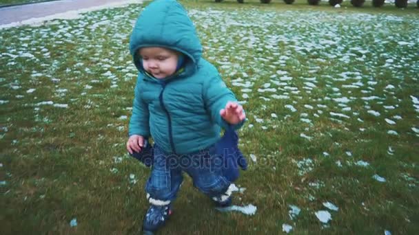 春天.替身拍摄的孩子跑下人行道, 草地和融化的雪。慢动作 — 图库视频影像