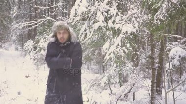 Genç bir adam kış ormandaki dondur. O Don, onun elleri ve sekerek losyonları