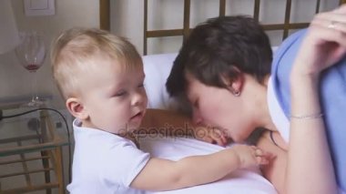 Anne bir yaşındaki oğlu odasında kızıyor. Çakışma anne ve çocuk.