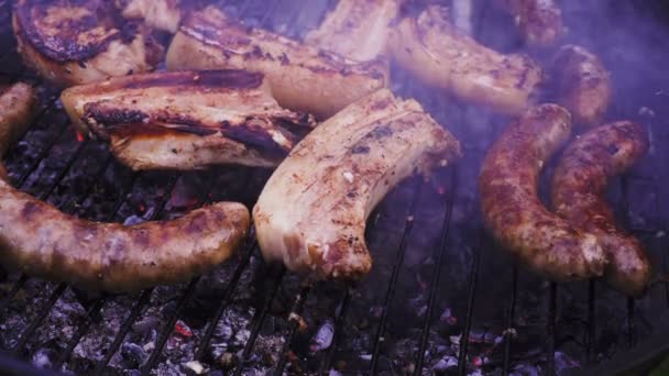 Chef is flipping meat on grill. Barbecue meat preparing on grill, close up. Mutton or pork grilling. — Stock Video