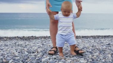 Küçük bir bebek çocuk oyun ve annesi ile Sahilde yürüyüş