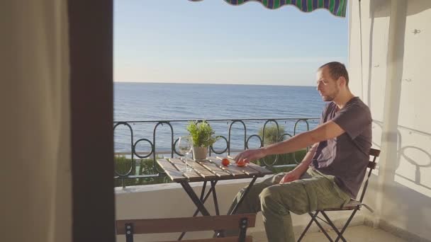 Man in looks at the ocean from a balcony on Nerha. Spain. — Stock Video