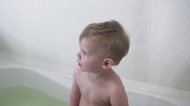 Söt baby boy tar ett bad i badrummet — Stockvideo