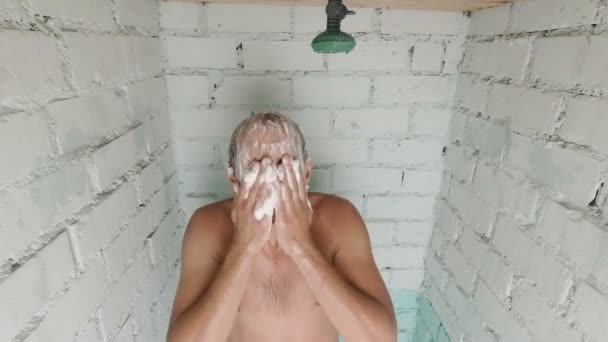 Szakállas vicces ember vesz egy zuhany és a fejét a vintage tégla fürdőszobában samponozás — Stock videók