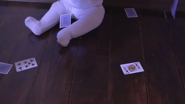 Bebê recém-nascido joga as cartas de jogo na sala — Vídeo de Stock