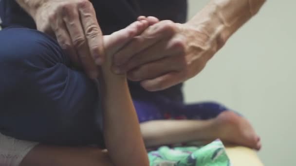 Крупним планом мама робить масаж ніг новонародженому хлопчику — стокове відео