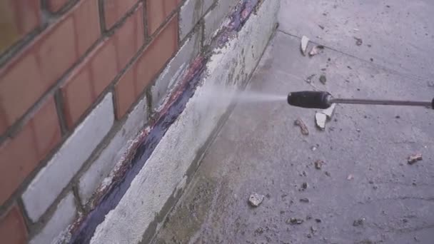 Outdoor floor cleaning with high pressure water jet. care of a country house. — Stock Video