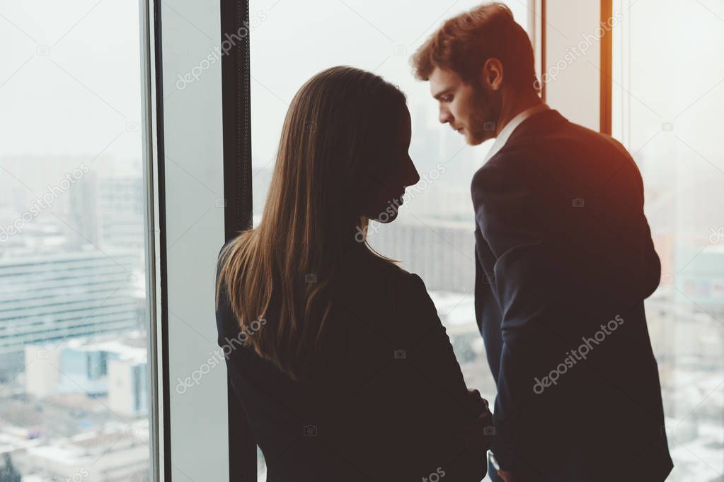 Group of business people man and woman standing near window
