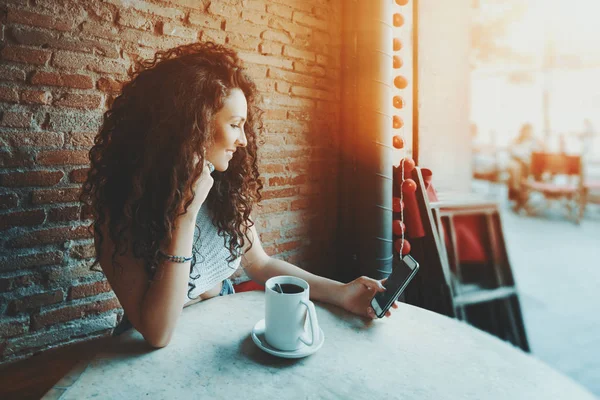 Curly girl is making selfie in cafe — Stock Photo, Image