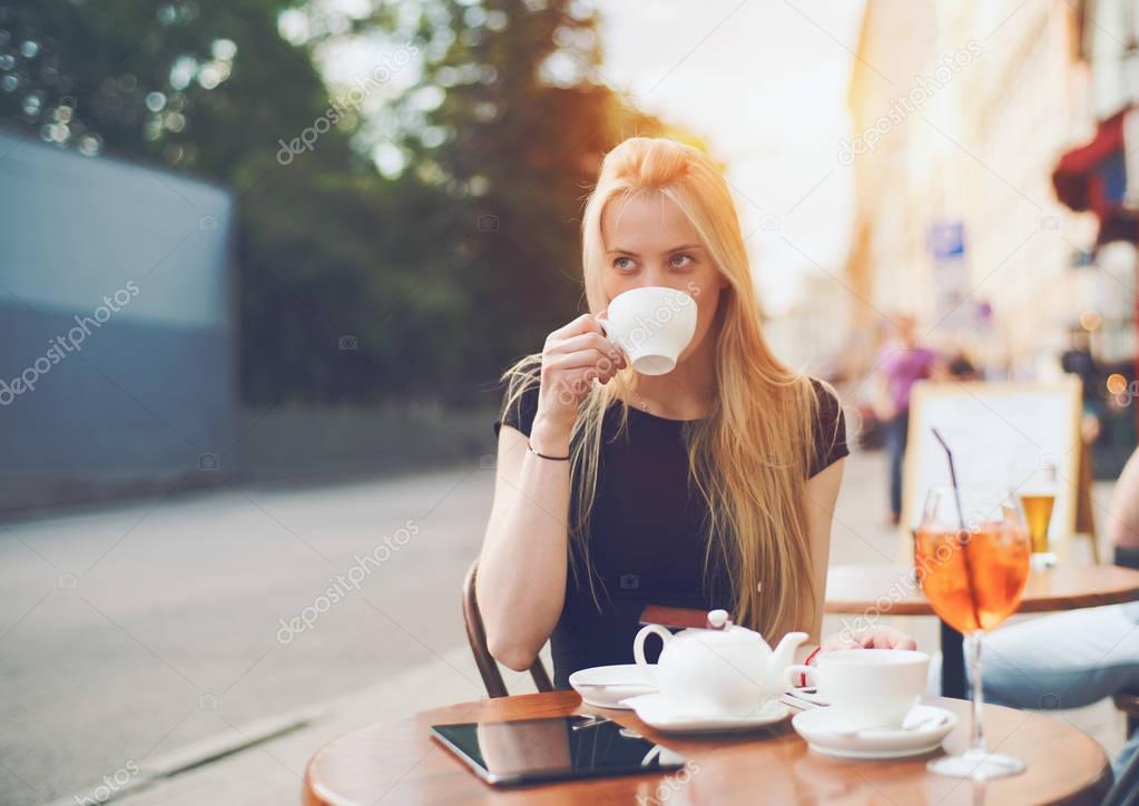 Charming blonde girl with cup of tea