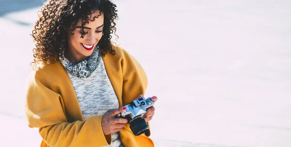 Curly smiling woman with vintage camera — Stock Photo, Image