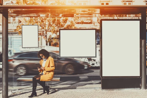 Mujer dentro de la parada de autobús con varias pancartas simuladas —  Fotos de Stock