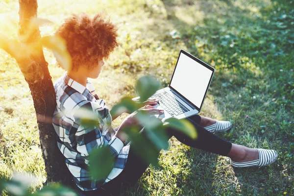 Curly black feemale student with laptop in park — Stock Photo, Image
